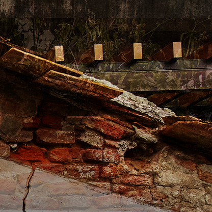 Close-up of a stone wall with a wooden beam and grass in the background