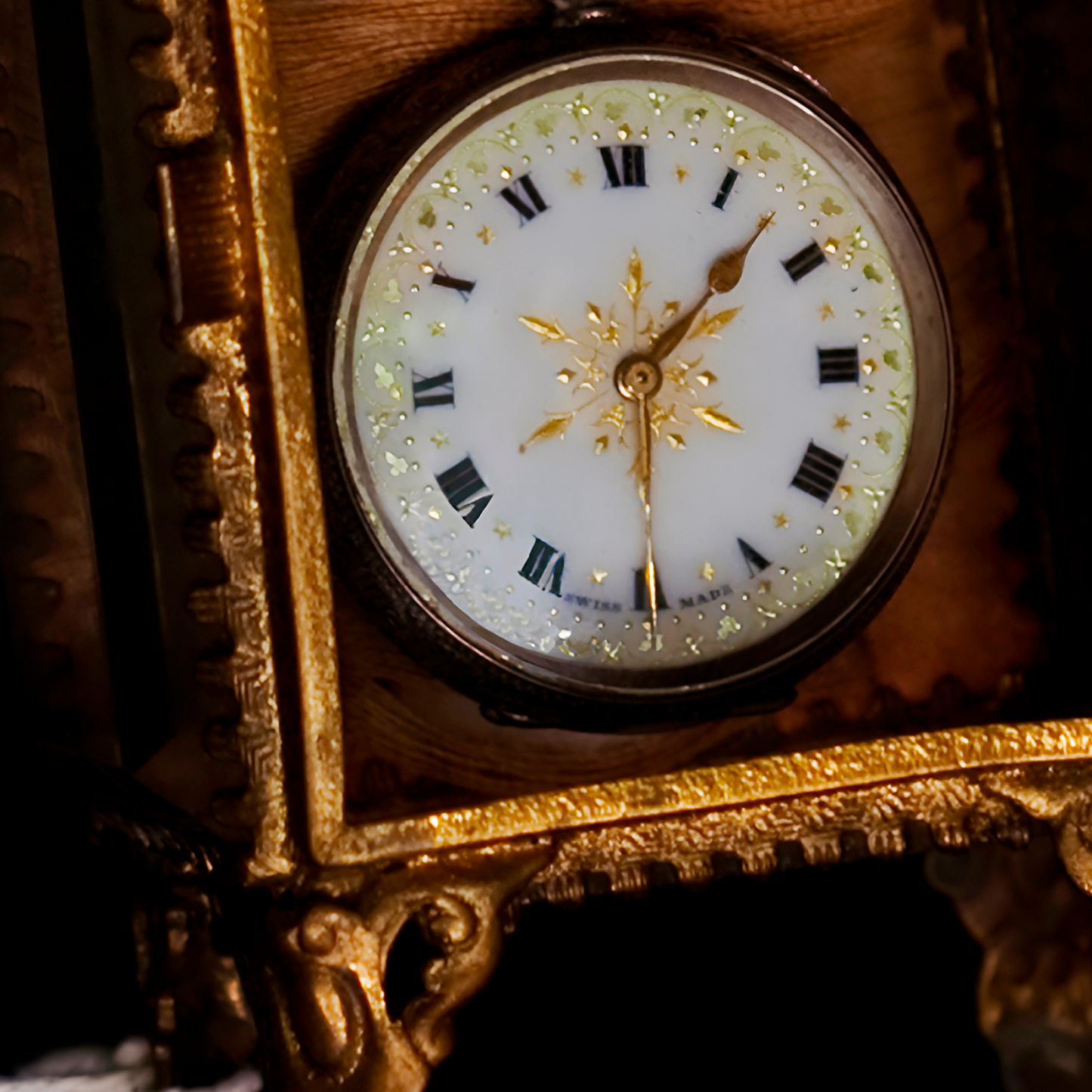 Decorative clock with gold frame and white face with black Roman numerals