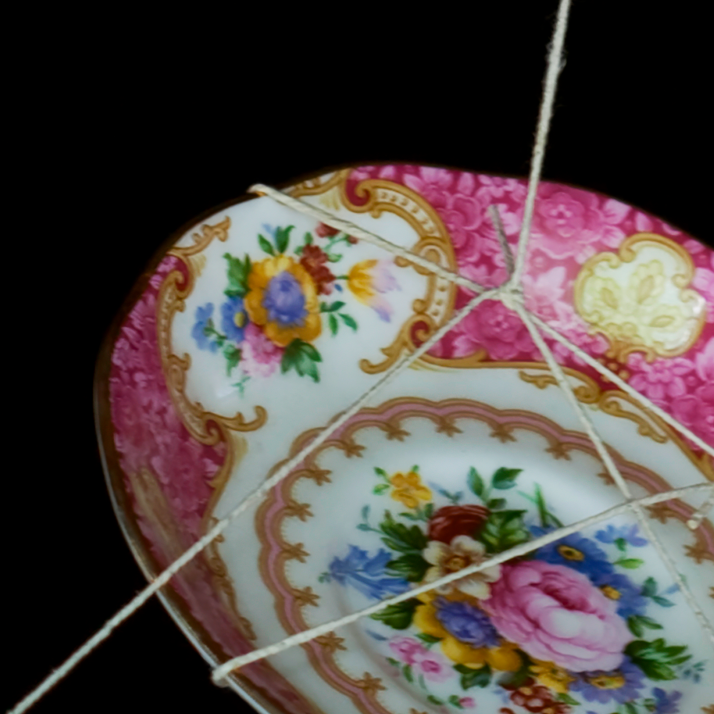Ceramic plate with floral design on a black background