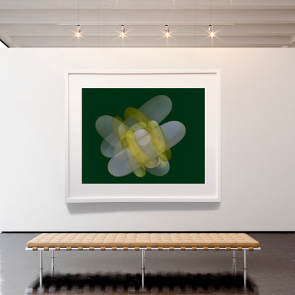 Framed abstract art piece on a wall above a wooden bench.