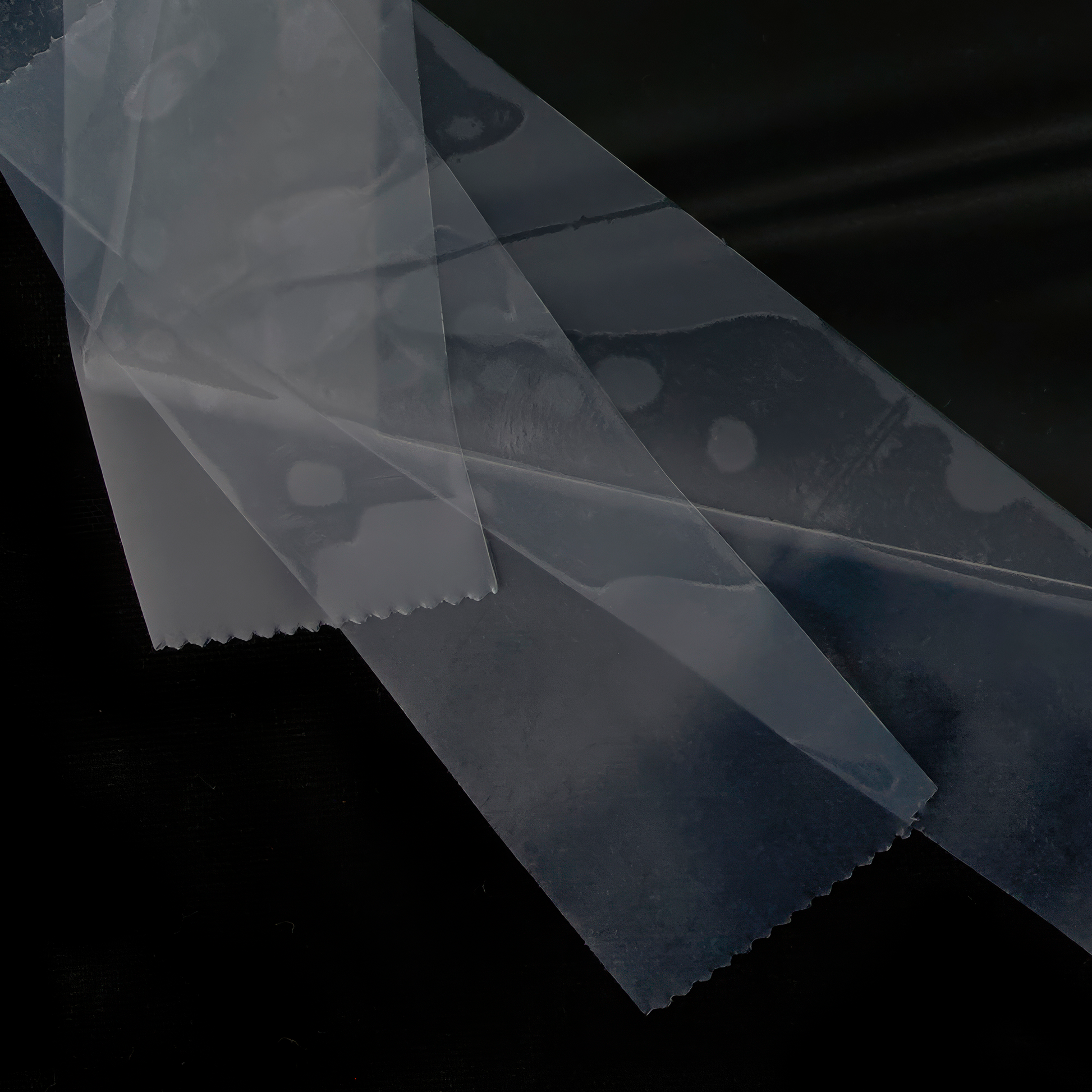 Close up of photograph of image of a reflection of a puddle wrapped in plastic