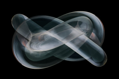 Abstract gray smoke-like abstract sculpture on a black background